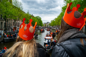 Two women wearing orange hats in King's Day Amsterdam